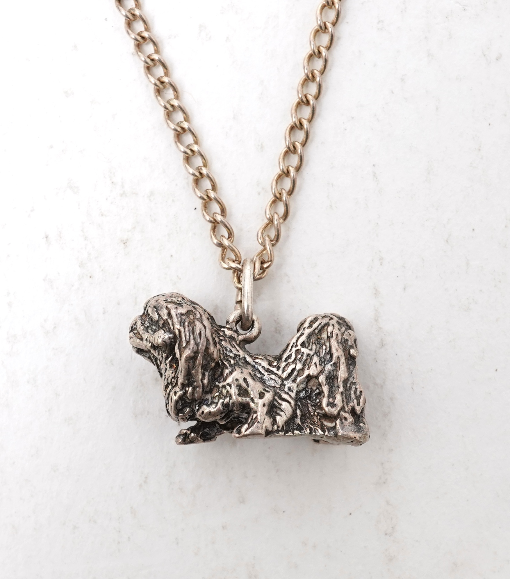 A collection of jewels including an Art Deco silver cigarette case